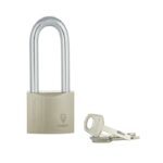 Beige padlock with a silver U-shaped shackle and two keys nearby.