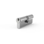 Metal door lock cylinder with keyhole shown at an angle on a white background