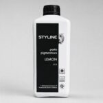 White plastic bottle with a tall black vertical label reading STYLE, pasta pigmentowa, LEMON, against a gray background.