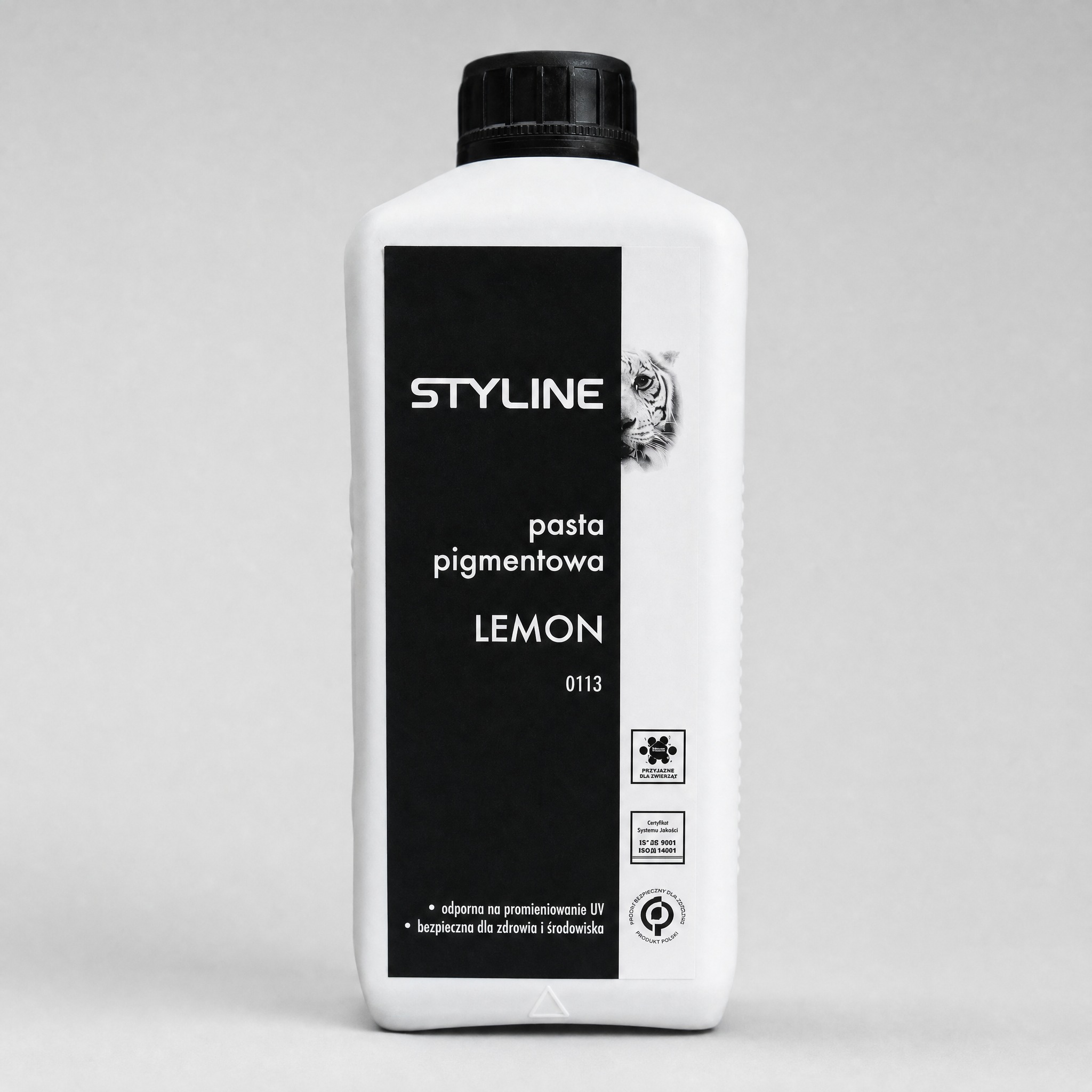styline-pigment-lemon - Mega Budowlany White plastic bottle with a tall black vertical label reading STYLE, pasta pigmentowa, LEMON, against a gray background.