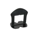 Small black plastic handheld punch tool with a rectangular opening and curved base; likely a belt or hole punch device.