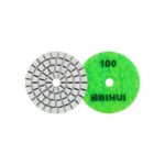 Two circular grinding discs: a gray segmented abrasive wheel and a bright green 100-grit polishing pad.