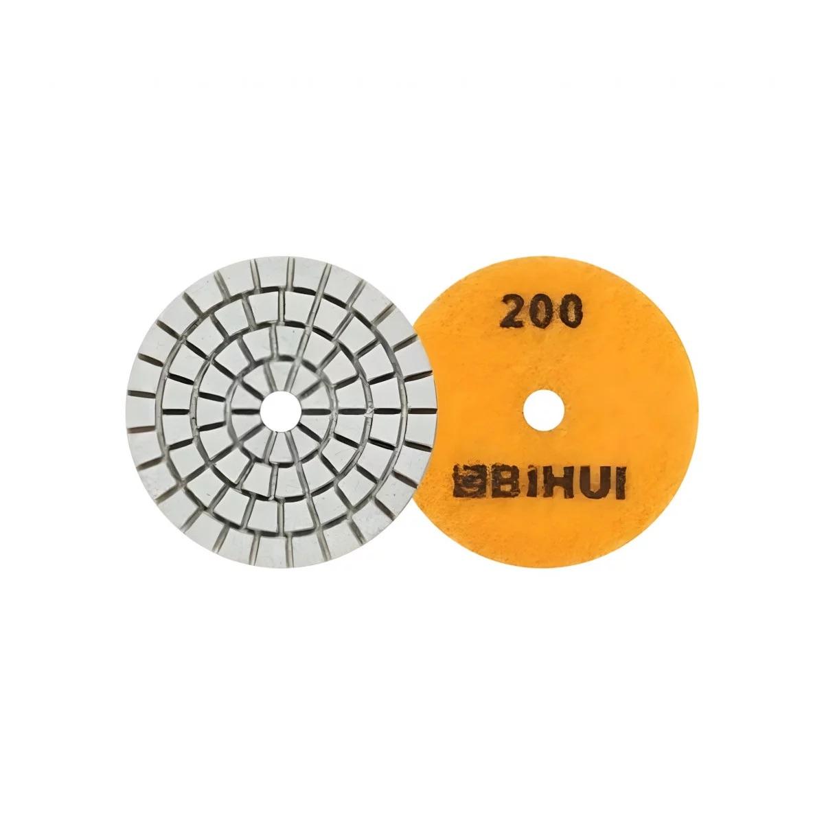 megabudowlany-bihui-mini-pad-polerowanie-na-mokro-p200-50mm-sklep-budowlany - Mega Budowlany Two circular abrasive tools: a segmented metal grinding wheel and a yellow 200-grit polishing disc.