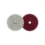 Two circular abrasive discs: a segmented gray grinding wheel and a red polishing pad with a central hole