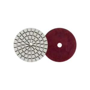 Two circular abrasive discs: a segmented gray grinding wheel and a red polishing pad with a central hole