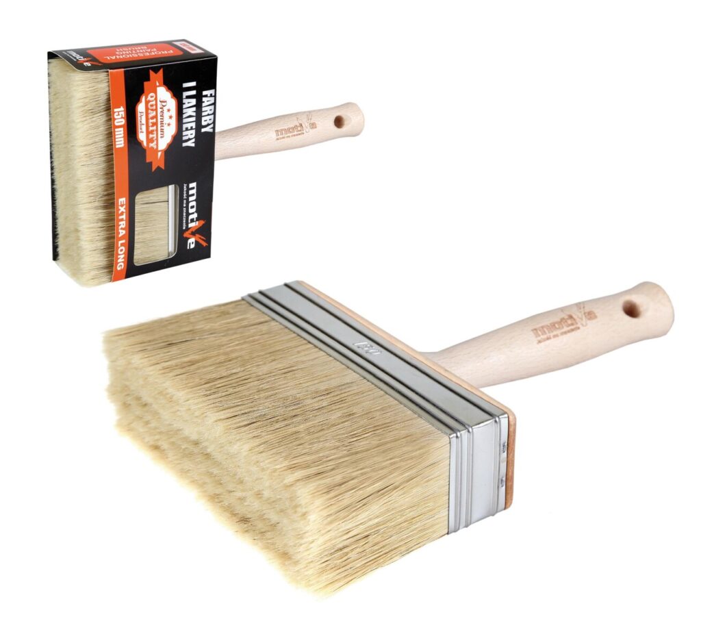 Wide natural-bristle paintbrush with wooden handle and metal ferrule, shown with its packaging at left edge (paintbrush set)