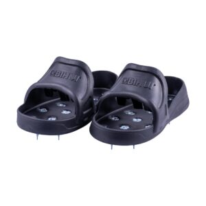 Pair of black slide sandals with metal spikes on the soles for traction.