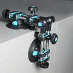 Modular blue-and-black adjustable clamping jig attached to a cabinet edge for panel alignment and securing parts