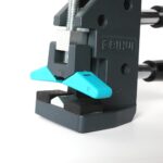 Close-up of a BIHUI bench clamp with bright blue levers secured to a dark gray base, on a white surface.