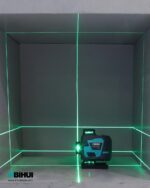 Green laser level projecting vertical and horizontal lines across a box interior; device sits at lower-right labeled BIHUI.