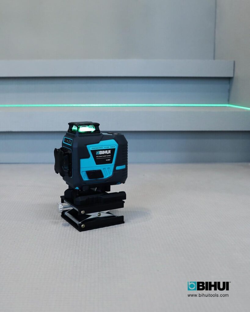 Blue BIHUI laser level on a black mounting base projecting a bright green horizontal line across a light-gray work surface, logo visible in the corner.
